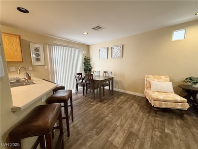 Dining area with dark wood finished floors and rec