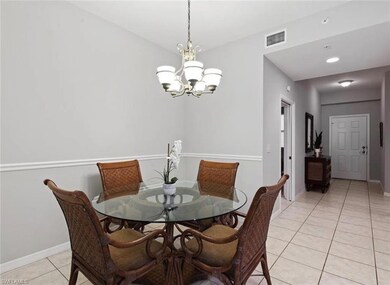 Tiled dining area with a chandelier