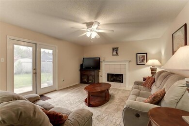 Den has fireplace and French doors opening to the