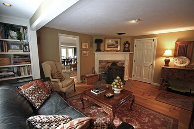 Wood burning stove set on a brick hearth with cust