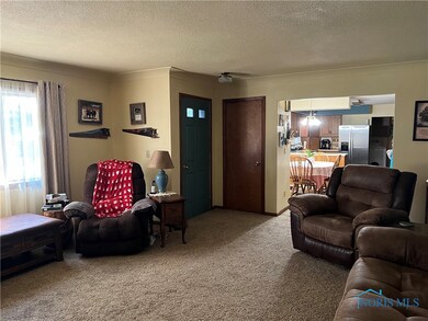 View of front door and kitchen/dining area