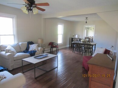 LIVING ROOM & DINING ROOM COMBINATION.... NEW HARDWOOD, NEW PAINT AND CEILING FAN 