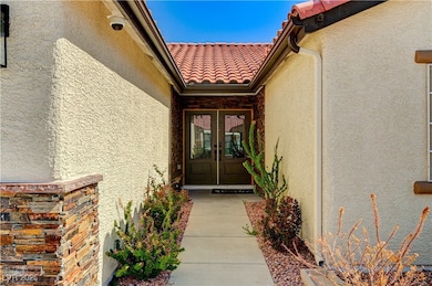 Entrance to property with french doors, stucco sid
