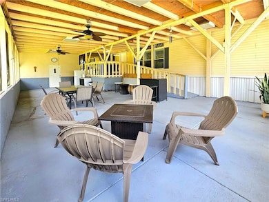 View of patio / terrace with a fire pit, outdoor dining area, and ceiling fan