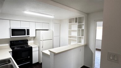 The kitchen features freshly painted cabinets, and
