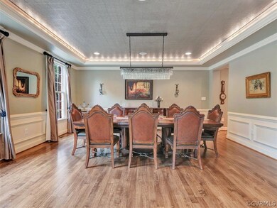 Huge Formal Dining Room with inverted tray lighting , crown moulding, chair rail and located off the foyer and easy access to the kitchen