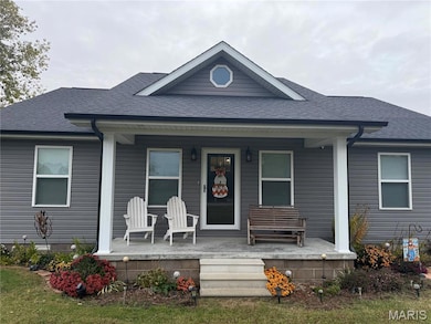 View of front of house with a porch and roof with shingles