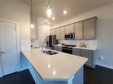 Kitchen featuring stainless steel appliances, gra