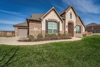 French country inspired facade featuring brick sid