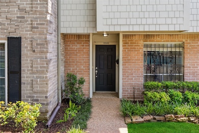 Charming front entrance with a black door, surroun