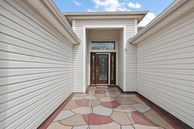Covered front entrance with elegant leaded glass d