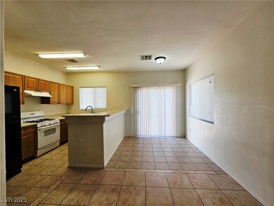 Kitchen with white range with gas stovetop, under
