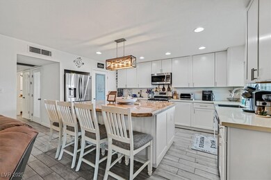 Kitchen with visible vents, a sink, stainless stee