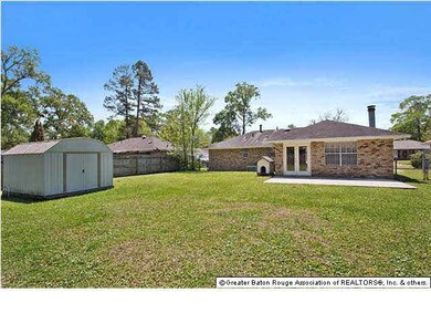 Large fenced in back yard with detached storage sh