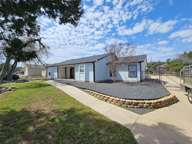 View of front facade featuring a front yard and f