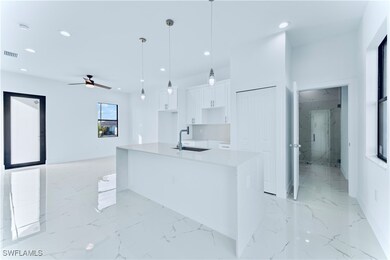 Kitchen featuring ceiling fan, sink, decorative li
