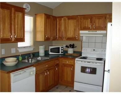 Kitchen. Oak cabinetry with white appliances