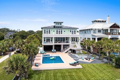 Rear view of house with a patio, a fenced backyard, stairs, a pool with connected hot tub, and a balcony