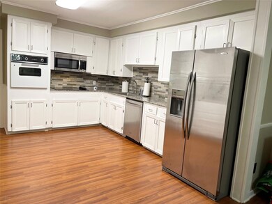 Kitchen featuring stainless steel appliances, whit