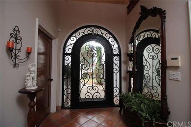 Entry way depicting wood and wrought iron door