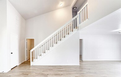 Stairs featuring high vaulted ceiling and hardwood