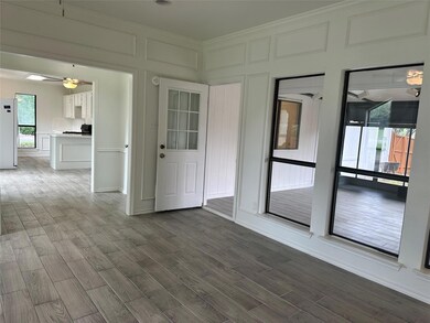 Kitchen with ceiling fan, light hardwood / wood-style flooring, white cabinets, and white fridge with ice dispenser
