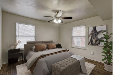 Bedroom with ceiling fan and dark hardwood / wood-