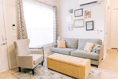 Living room with a wall mounted air conditioner a