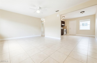 Spare room with light tile patterned flooring and ceiling fan