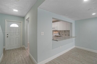 View from dining room looking to kitchen and entra