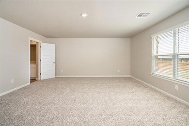 Relax in the oversized primary suite complete with