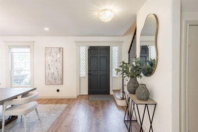 This inviting entryway features a stylish black fr