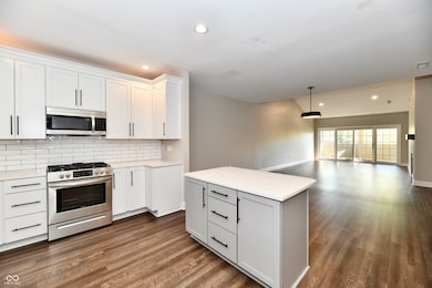 Kitchen with stainless appliances, and subway backsplash.