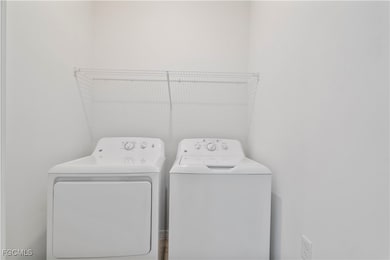 Washroom with washing machine and clothes dryer