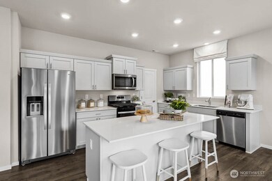 Beautiful modern kitchen space. Actual home is under construction. Colors, materials, and features may vary. See site agent for details.