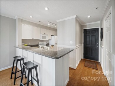 Close up of kitchen with granite and bar area