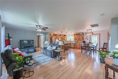 View from front door, living area to left, dining area is straight ahead, all are open to kitchen area.  Great entertaining area.