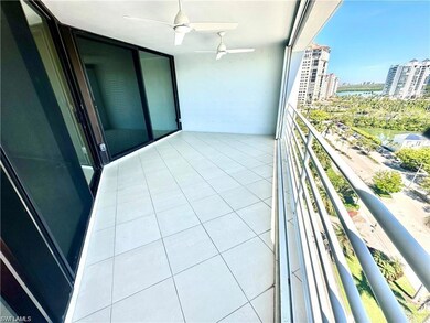 Balcony featuring a water view and a ceiling fan