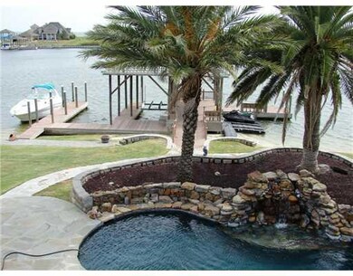 View. Gorgeous pool area w/rock wall & waterfall s