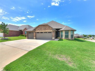 View of front of property with a garage, a front yard, concrete driveway, brick siding, and a shingled roof