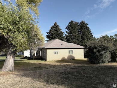 View of side of home featuring a yard and brick siding