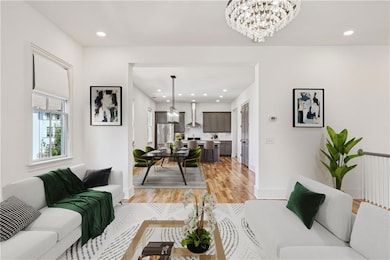 Living room with a notable chandelier and light wo