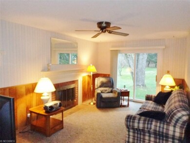 Family room with fireplace, ceiling fan and slider