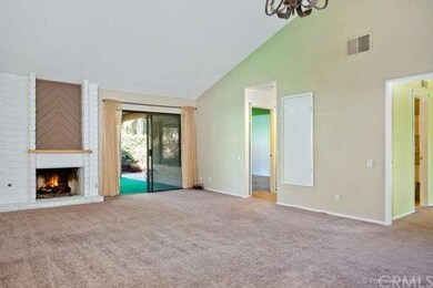 View of fireplace and enclosed backyard
