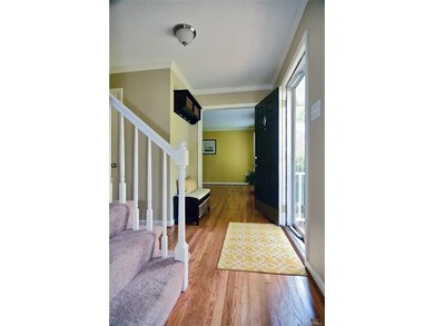 Inviting foyer with hardwood floors.