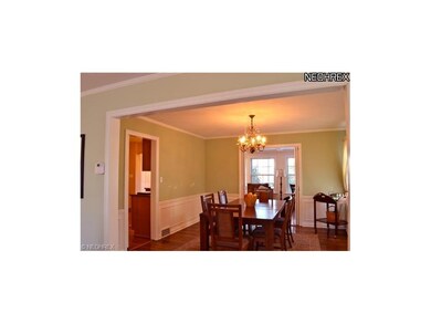 Dining room with family beyond.