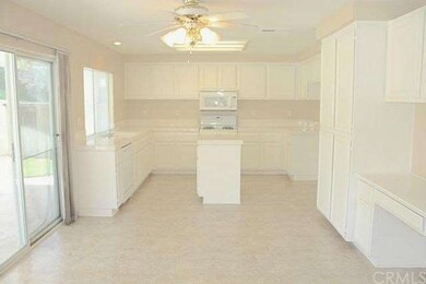 Super large kitchen has newly painted cabinets wit
