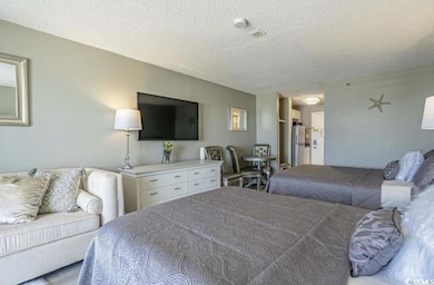 Bedroom with a textured ceiling and freestanding r