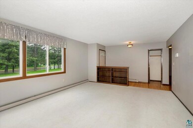 Unfurnished bedroom featuring baseboard heating, c
