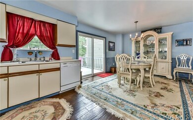 Dining room and kitchen combination boasts hard wo